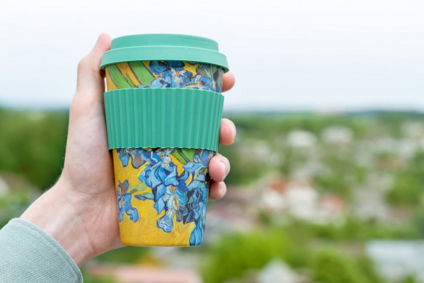 male hand holding colorful mug with nature backgro 2023 11 27 04 50 13 utc